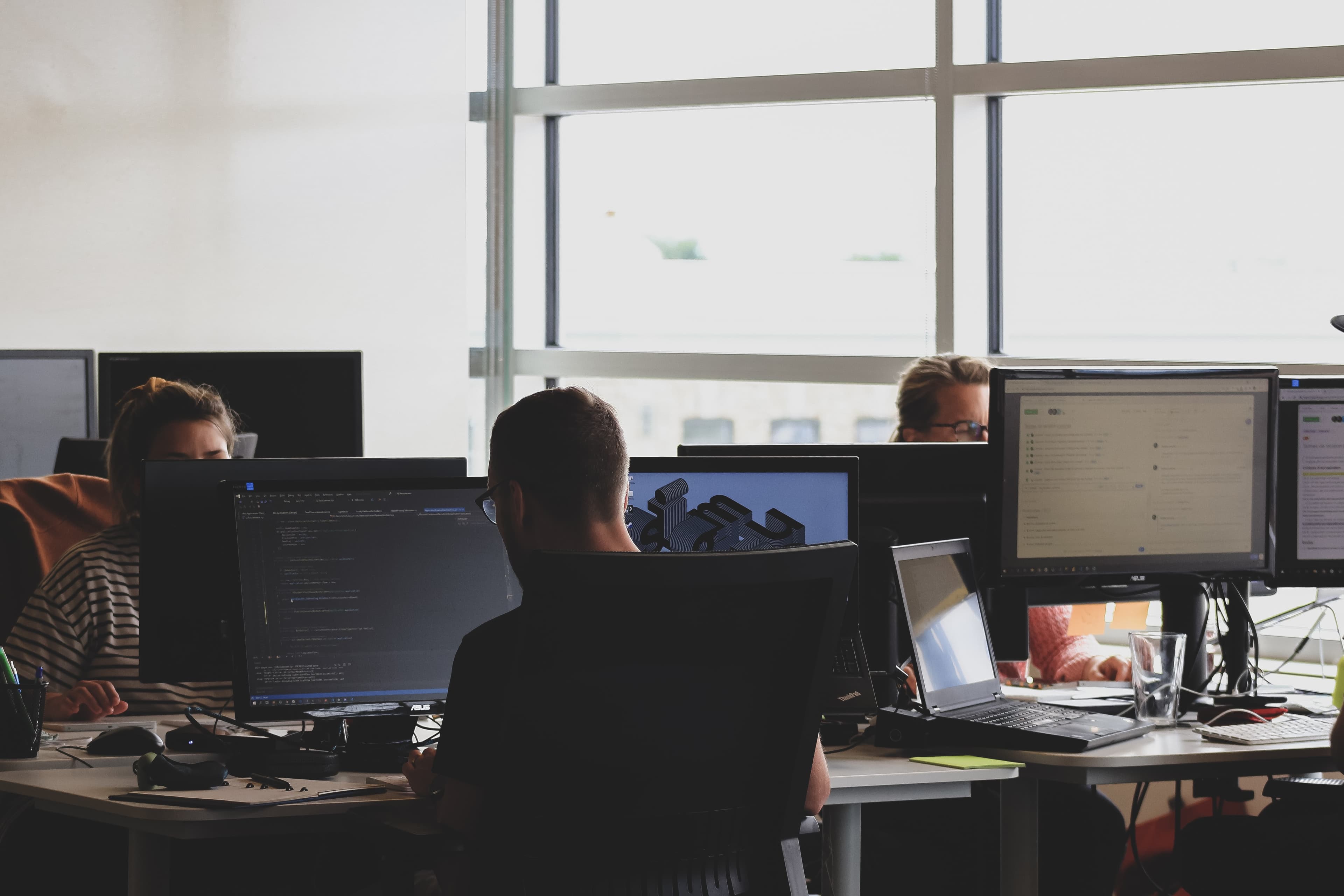 actuaries at work at a set of computers