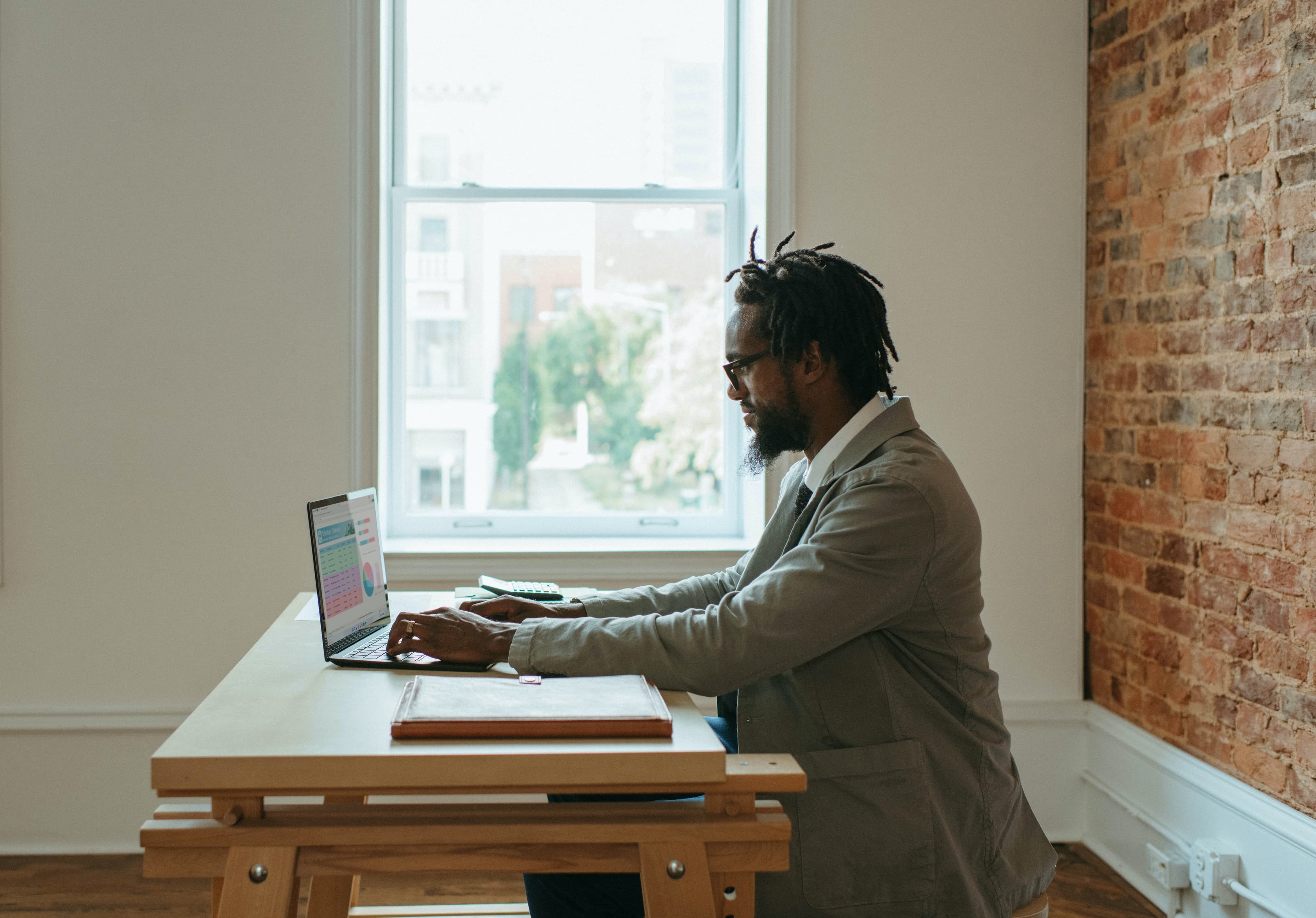 an actuary working on a spreadsheet on a laptop