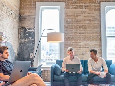 group of three actuaries working on laptops